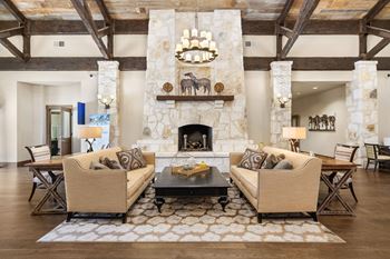 A living room with couches and a table and a fireplace